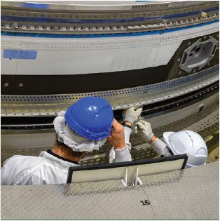 Workers at Europe’s spaceport in French Guiana hoist the upper composite flight models for the Ariane 6 program. France remains the largest European space employer.